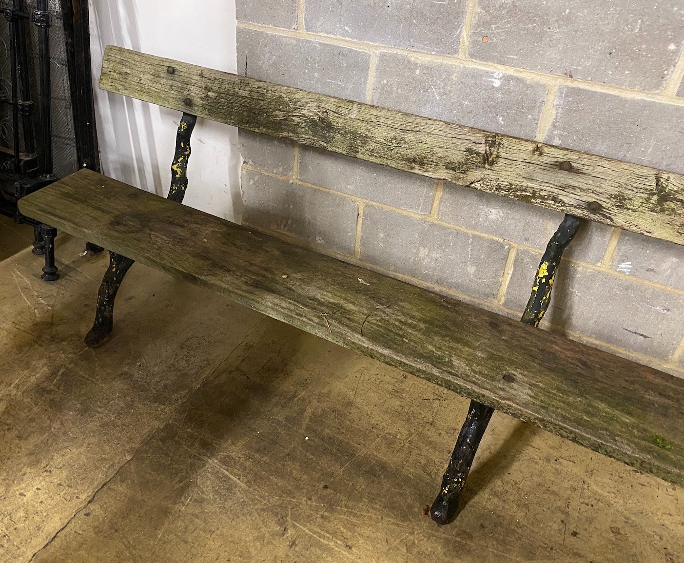 A Victorian cast iron garden bench with rustic ends and teak seat, length 305cm, depth 60cm, height 81cm